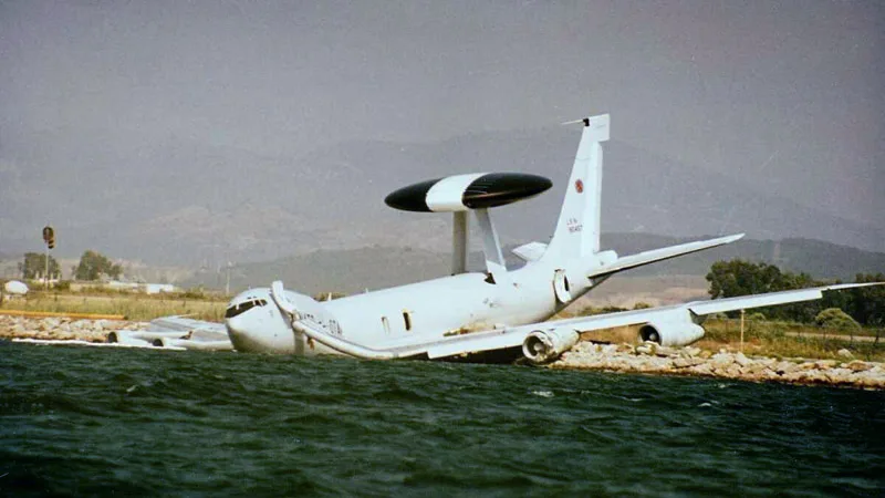 A Boeing E-3 Sentry, registration LX-N90457, after a post-V1 takeoff abort at Prevesa AB in Greece. The airframe split into two after dropping down to the shore. No casualties were reported, although the airframe was a total loss.