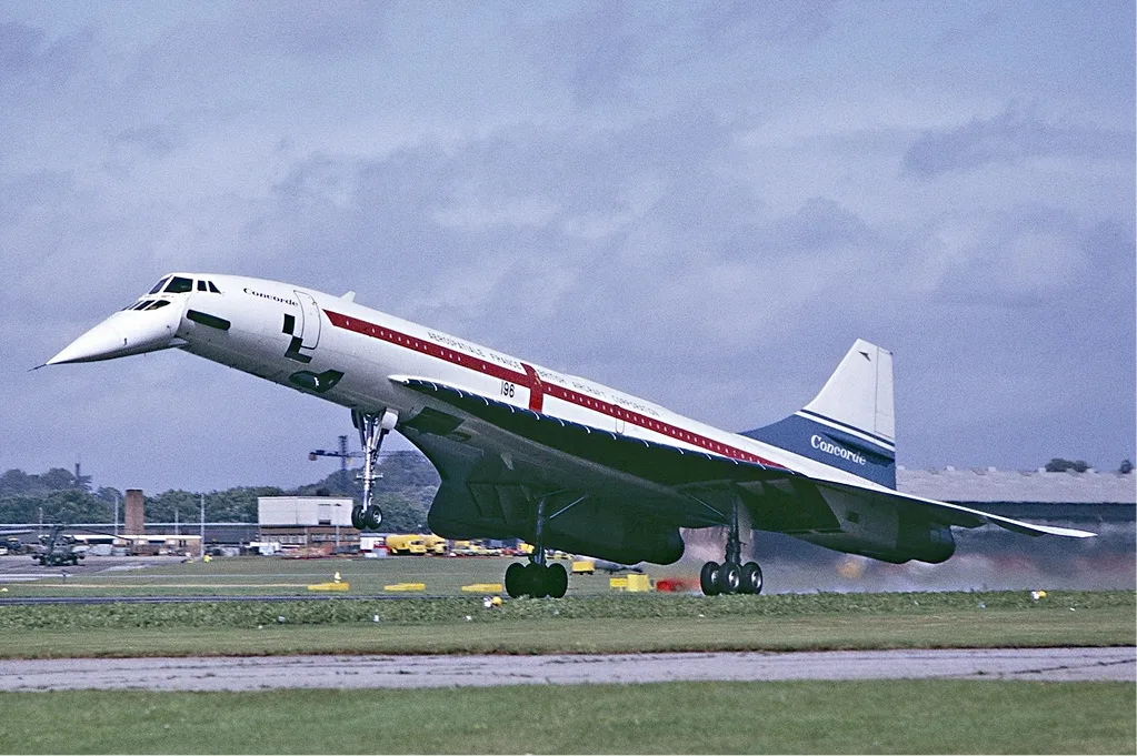 Touchdown during a sunny break between the showers. The famous Black Sheds just visible through the heat haze from the four Olympus engines
