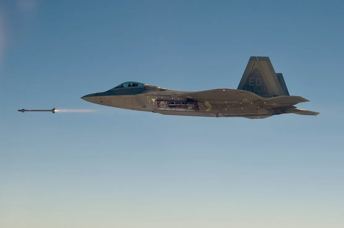 411th Flight Test Squadron flagship Lockheed Martin F-22A Block 30 06-4132 test fires an AIM-9X.